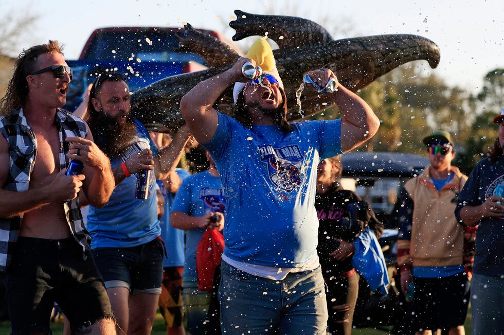 Larry Donnelly, of St. Augustine, double-fists two beers as team "Hanky Spanky" is announced...