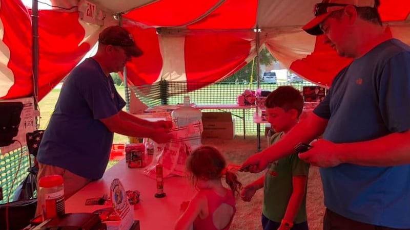 A family purchases fireworks Sunday afternoon at TC Fireworks during the first day of sales in...